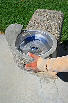 Hand Pushing Water Fountain