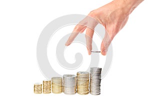 Hand put coin to money staircase