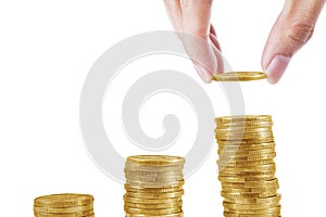 Hand put coins into stack of coins