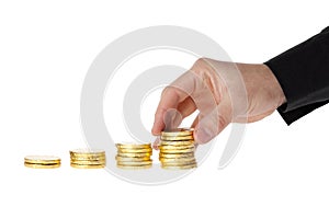 Hand put coins into stack of coins photo