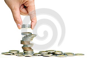 Hand put coins stacked on each other in different positions on white background,Savings money and income or Investment Ideas and
