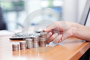 Hand put coins to stack of coins. Business growth concepts