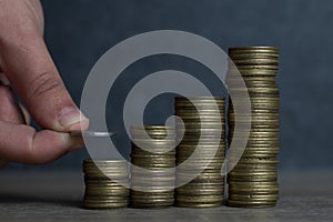 Hand put Coins to stack of coins,Concept Saving money