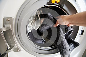 Hand put dirty cloth in washing machine