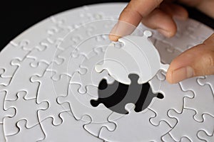 Hand put the last piece of jigsaw puzzle to complete the mission, Business solutions, success and strategy concept, The solution
