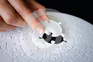 Hand put the last piece of jigsaw puzzle to complete the mission, Business solutions, success and strategy concept, The solution