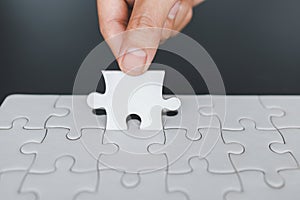 Hand put the last piece of jigsaw puzzle to complete the mission, Business solutions, success and strategy concept, The solution