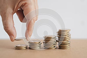 hand put money coins to stack of coins. Money, Financial, Business Growth concept