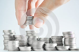 Hand put money coins to stack of coins, Money, Financial, Business Growth and saving money concept.