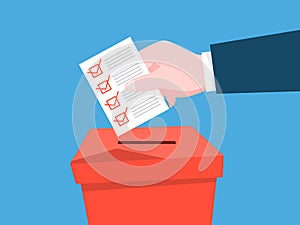 Hand put paper with a sign in a ballot box. Political election photo