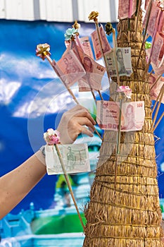 Hand put thai banknote in make merit