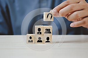 Hand put wooden cubes with Inbound marketing icons and symbols on table and copy space.Business concepts