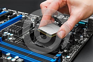 Hand puts computer processor on motherboard