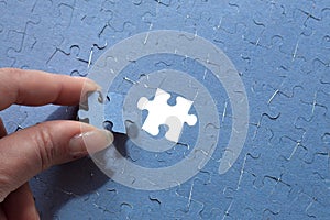 hand puts the last element of the puzzle, finding a suitable solution, completing the project