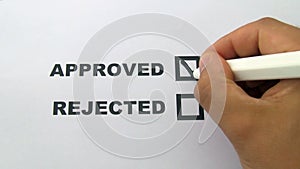 Hand puts a sign in approved check box