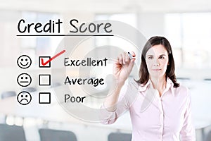 Hand putting check mark with red marker on excellent credit score evaluation form. Office background.