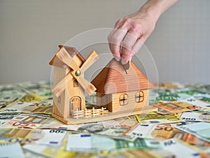 Hand Putting Coin In money box