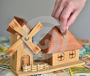 Hand Putting Coin In money box