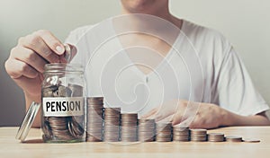 Hand putting coins in jar word pension with money stack step growing growth saving money, Concept finance business investment