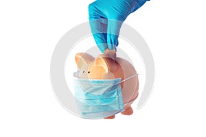 Hand putting golden bitcoin into piggy bank with mask for saving money wealth and financial concept photo