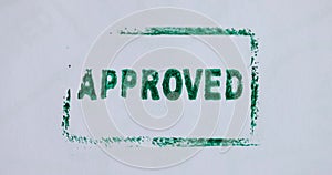 Hand putting green stamp approved on important document closeup 4k movie slow motion