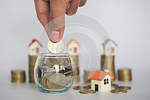 Hand putting money coin stack , buy a house,Risk, Indicates the growth of home and finance, planning savings money of coins to