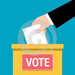 Hand putting paper in ballot box.