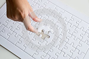 Hands putting piece to white jigsaw puzzle,Success solution template,Concept partnership business successful teamwork photo