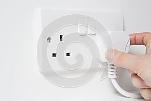 Hand Putting Plug Into Electricity Socket