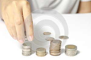 Hand putting stack of coins