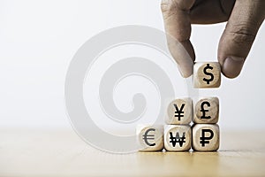 Hand putting use dollar sign on the main currency sign include yen euro and pound for trading forex and currency exchange concept