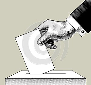 Hand putting voting paper in the ballot box photo
