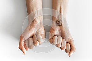 Hand with QR Code on wrist. Future of political population control. Chipization