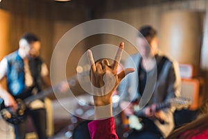 Hand raised showing a heavy metal rock sign
