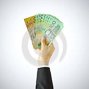 Hand raising money, Australian Dollar bills (AUD)