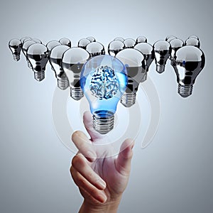Hand reach 3d metal brain inside light bulb