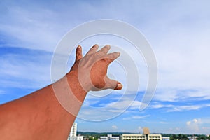 Hand reach up blue sky background