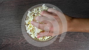 Hand reaches for popcorn