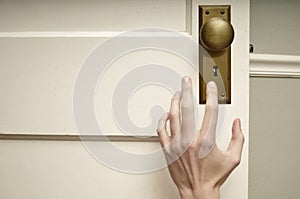 Hand reaching for doorknob