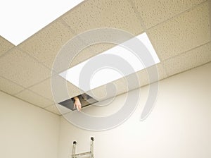 Hand reaching from hole in ceiling