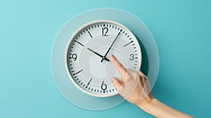 hand reaching out to a white wall clock on a light blue background, seemingly to adjust the time..AI generated image