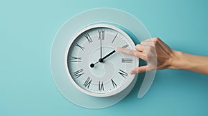 hand reaching out to a white wall clock on a light blue background, seemingly to adjust the time..AI generated image