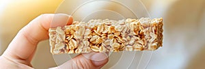 Hand reaching for portable granola bar, showcasing convenient on the go snacking