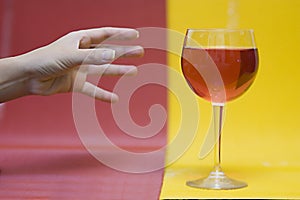 Hand reaching for wine glass