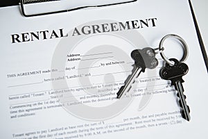 Hand of realtor agent giving keys of apartment to new tenant after sign rental agreement