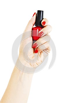 Hand with red nail polish bottle