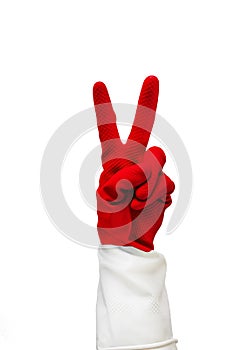 Hand in red rubber glove with two fingers are folded, showing what sign everything is cool. Isolate on a white background.