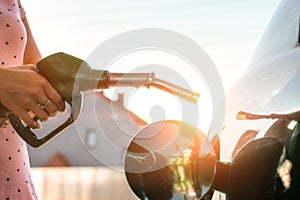 Hand refilling the car with fuel at the refuel station