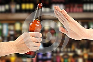 Hand reject a bottle of beer photo