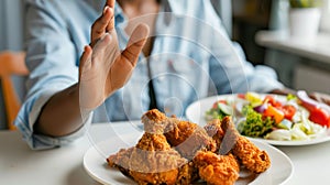 A hand rejecting fried chicken.AI generated image